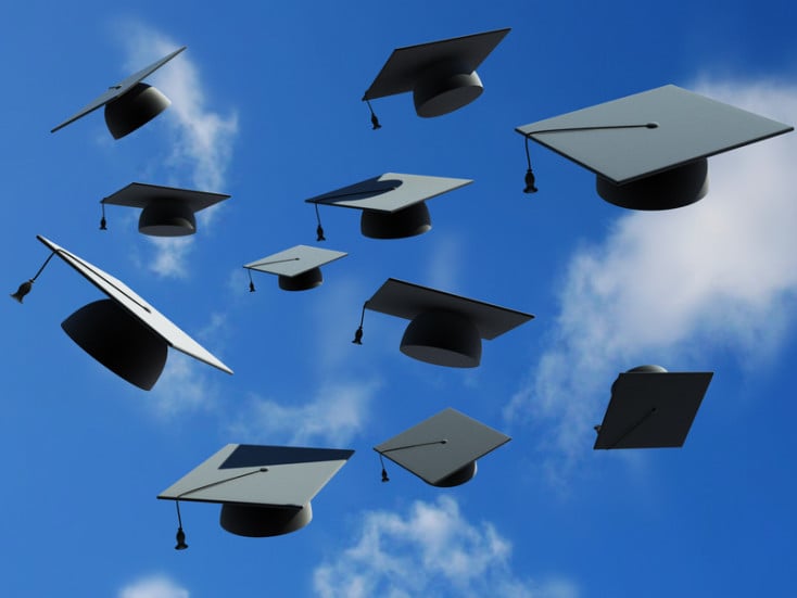 Graduation caps thrown in the air