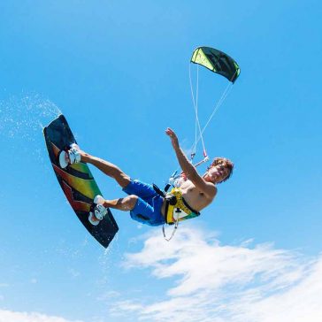 young man doing kitesurfing