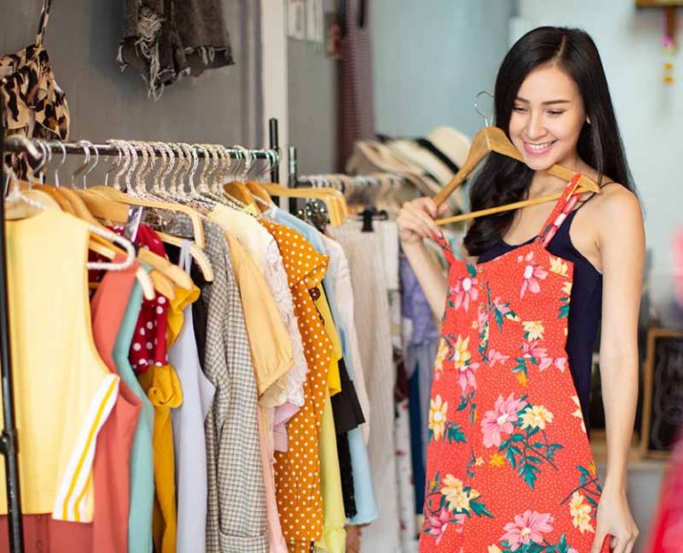 Girl trying on dress in fashion shop