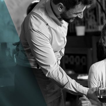 Waiter serving lady in restaurant