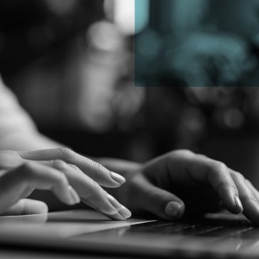 hands typing on a laptop