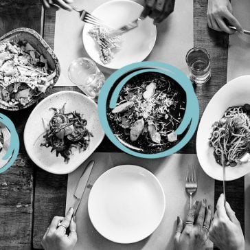 Table in restaurant full of food