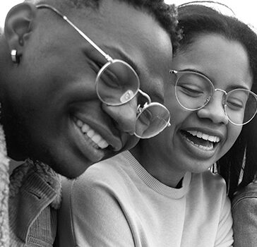 Young people laughing looking at a phone