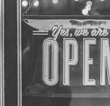 A shop window with a sign saying yes we are open