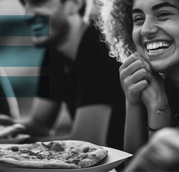 People eating pizza at a restaurant